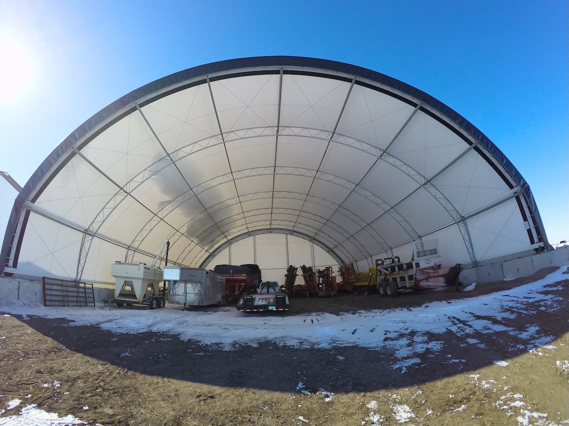 Image of a durable fabric hoop building with snow